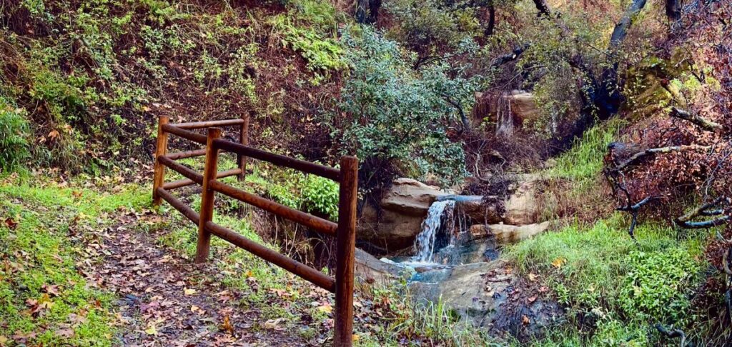Rustic wooden bridge over stream at Theatricum Botanicum outdoor theater in Topanga Canyon for Treasure Island production